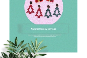 Detail of glitter hollow Christmas tree earrings with festive red holiday hat accents