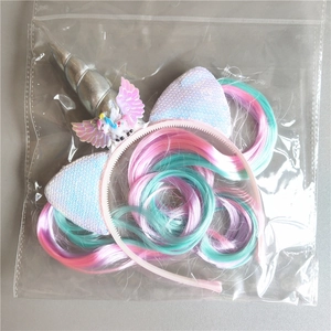 Unicorn headband set with colorful wig and shiny wings in clear plastic packaging