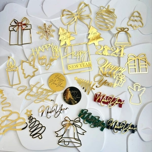 Flat lay of colorful acrylic Happy New Year and 2024 cake toppers in various shapes