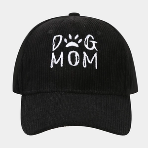 Close-up of black corduroy baseball cap featuring white DOG MOM embroidery texture