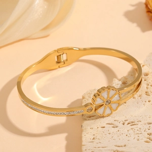 Elegant gold double-layered bangle with white enamel flowers and diamond accents