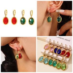 Macro shot of colorful oval gemstone earrings with stainless steel hooks and cubic zirconia