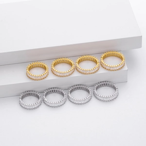 Set of eight gold and silver eternity rings with rectangular zircon stones on white display