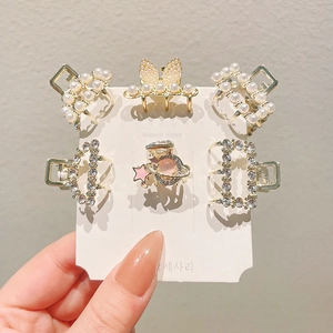 Set of 6 mini gold hair claws with pearls and rhinestones on card display