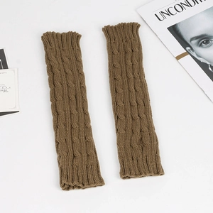 Close-up detail of brown cable-knit arm warmers with thick textured acrylic yarn