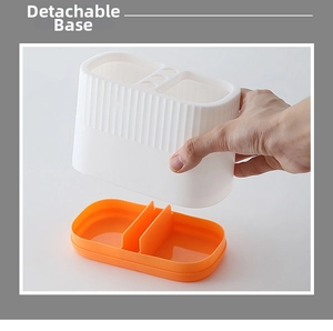 Detail showing the removable orange base of the dual-color desk organizer for easy cleaning