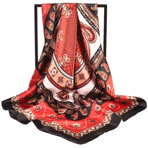 Detailed view of red and black paisley silk scarf draped on a display rack