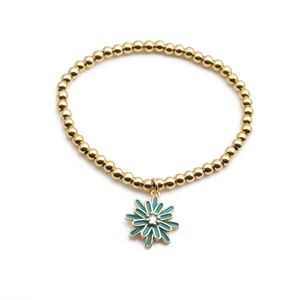 Détail du bracelet à billes dorées avec pendentif marguerite turquoise et zircon central