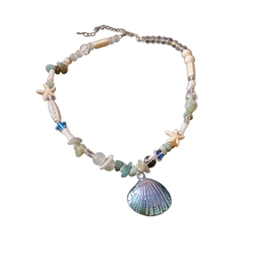 Acrylic ocean necklace with starfish charms and colorful sea shell beads on white background