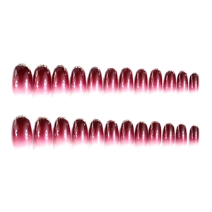 Elegant burgundy gradient press-on nails with gold glitter and oval shape design