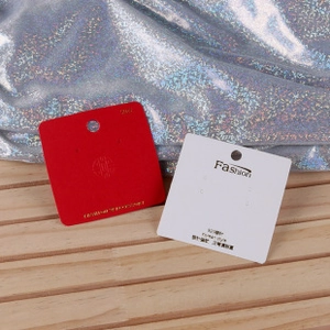 Detail of red and white cardboard jewelry cards for stud earrings and 925 silver pins