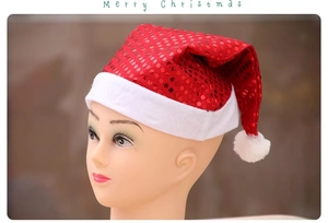 Close-up of red sequined Santa hat with white plush trim on model with Merry Christmas text
