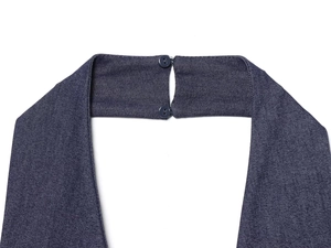 Detailed view of dark blue denim dress neckline with two round matching buttons