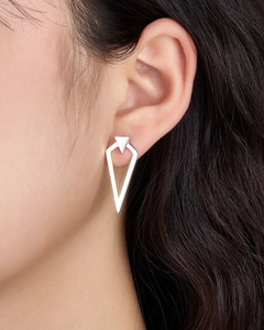 Close-up of minimalist S925 silver triangular geometric earrings worn by a model