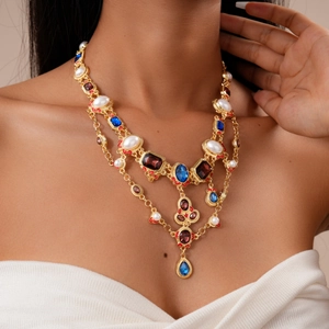 Detail of vintage multilayer necklace with colorful crystals and pearls on model