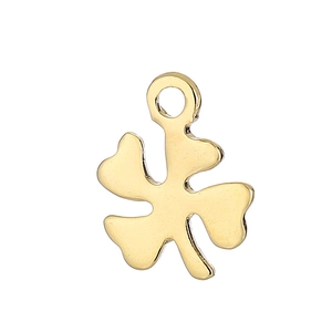 Close-up of a polished golden four-leaf clover pendant with a sleek metallic finish