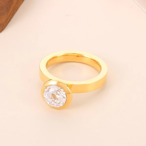 Gros plan d'une bague solitaire dorée avec un grand zircon rond serti en clos élégant