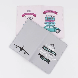 Detailed view of printed PU leather passport covers with travel quotes and icons