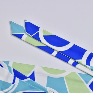 Detail of geometric pattern fabric showing crisp blue and green prints with precise edge stitching