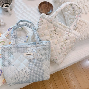 Quilted floral and plaid cotton tote bag with Simple Wish label on white bedding