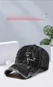 Close-up of vintage distressed dark denim baseball cap with stylish ripped details