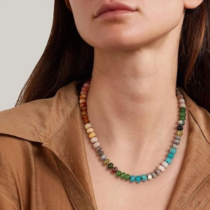 Detail of colorful bohemian natural stone beaded necklace on model neck