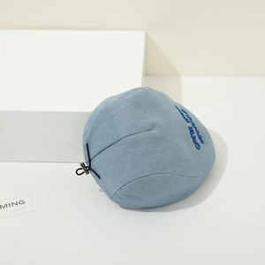 Detail of light blue denim baby beret with embroidery and adjustable drawstring toggle