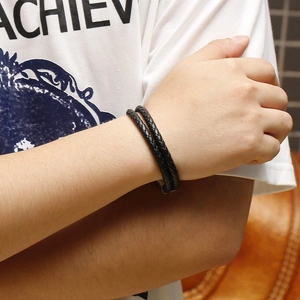 Detail of multi-layer black braided leather bracelet with a secure magnetic clasp for men