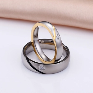 Two-tone matte titanium couple rings with single diamond accent and brushed metal finish