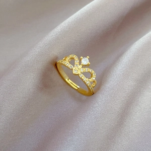 Macro view of gold crown ring featuring intricate cutout details and sparkling zircon stones