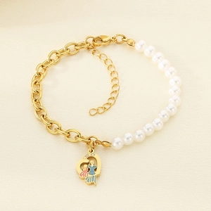 Close-up of titanium steel bracelet featuring half pearls and a heart silhouette pendant