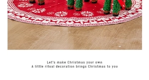 Close-up of red knitted Christmas tree skirt featuring white reindeer and snowflake motifs