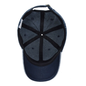 Interior view of vintage blue denim baseball cap with adjustable strap and wash label