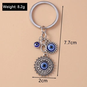 Retro Evil Eye keychain with sun pendant and size dimensions in detailed product view