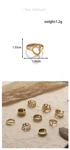 Detail showing various golden stainless steel rings with heart and chain designs