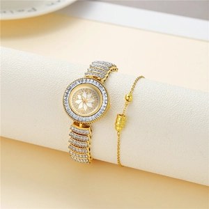 Detail shot of the gold-tone dial featuring a white floral pattern and crystal bezel