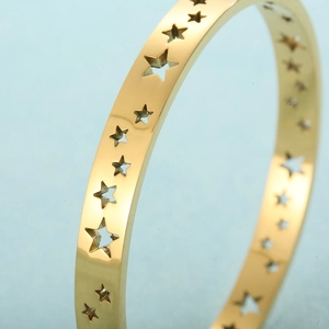 Macro shot of 18K gold plated stainless steel bracelet with cutout star pattern detail