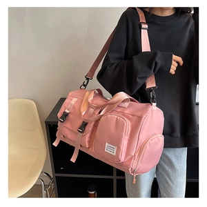 Detail view of pink fitness bag with side shoe compartment and waterproof fabric