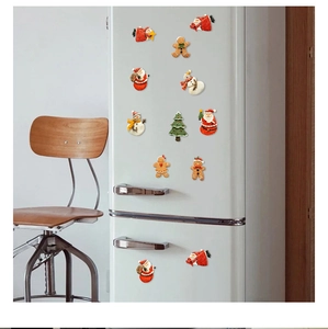 Christmas fridge magnet set featuring Santa and Gingerbread Man on a white refrigerator