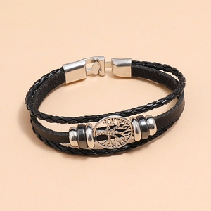 Close-up of black multilayer leather bracelet featuring a silver Tree of Life charm