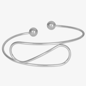 Macro detail of intertwined silver 304 stainless steel bangles with spherical end tips