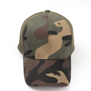 Detail of woodland camouflage trucker hat with green nylon mesh and curved brim