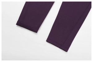Macro shot of high-elasticity dark purple yoga leggings with professional flatlock stitching
