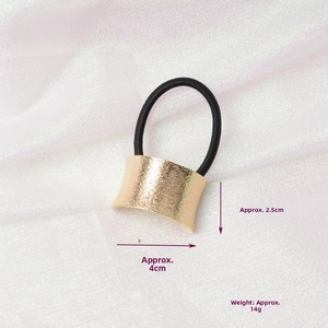 Detail of gold metal hair cuff with brushed texture, dimensions 4cm x 2.5cm