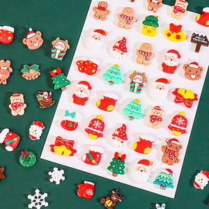 Flat lay of colorful Christmas resin charms including Santa, reindeer and trees for DIY crafts