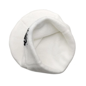 Close-up of white knitted beanie inner lining with soft texture and black pattern detail