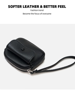 Detail view of black lychee grain leather wallet with silver zipper and wrist strap