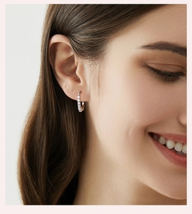 Close-up of elegant U-shaped 925 sterling silver earrings with moissanite on a model