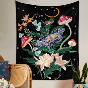 Detail of a black tapestry with butterfly and moon patterns on a beige wall with a chair