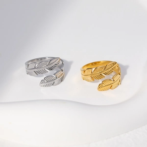 Detailed macro shot of adjustable feather rings in gold and silver stainless steel